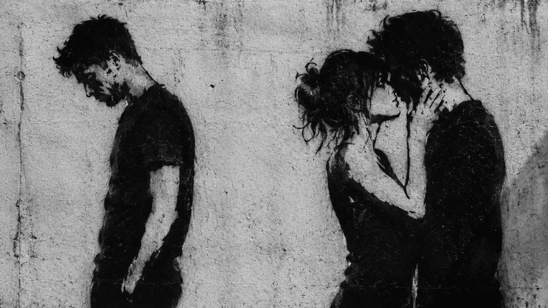street art stencil of a lonely, sad man separated from an intimately embracing couple